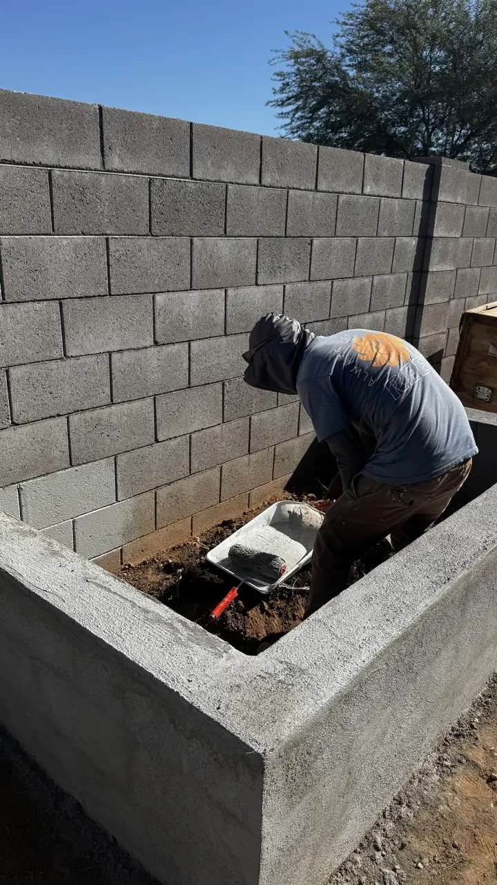 Masonry worker constructing a stuccoed CMU planter in the Phoenix Valley