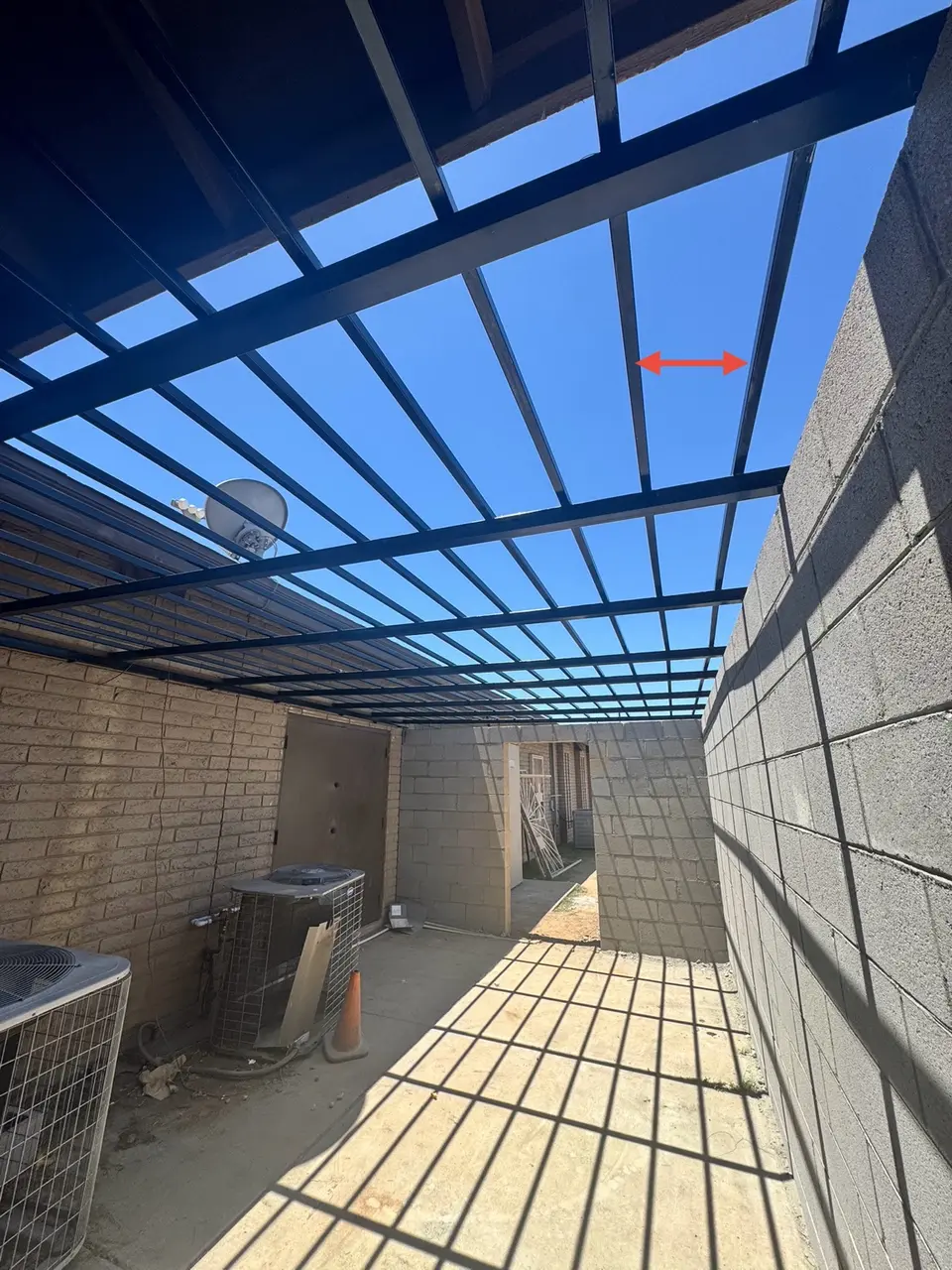Overhead steel framing installed above the Phoenix CMU enclosure