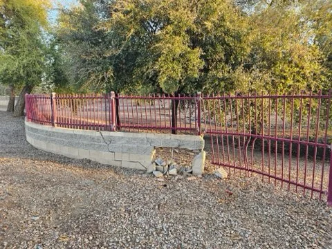 Before Block Wall Base & Metal Fence Repair in Glendale, AZ